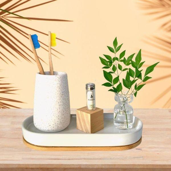 Bamkiki_Sustainable_Eco_Friendly_zero waste oral care bamboo toothbrush adult size blue and yellow and eco friendly dental floss in a tray