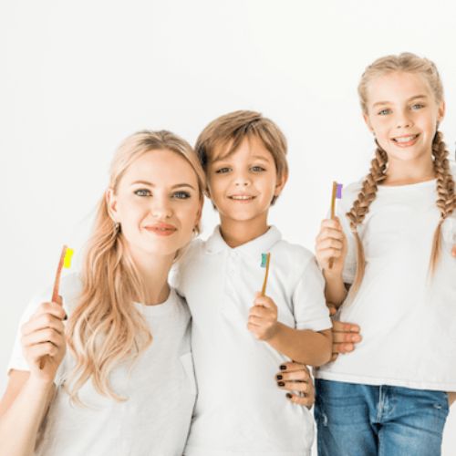 A mother and two children using Bamkiki eco friendly biodegradable sustainable bamboo toothbrush